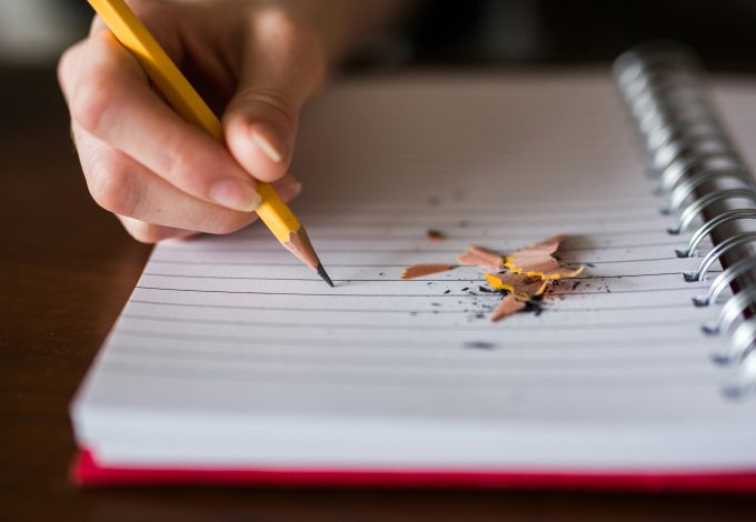 Author writing ideas in a notebook
